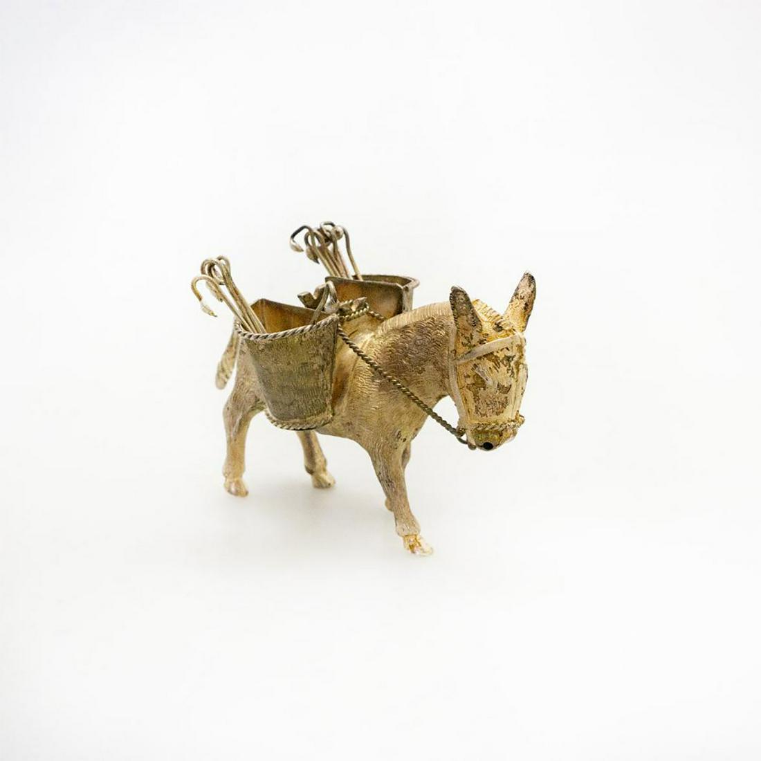 Vintage Metal Donkey Toothpick Holder, El Burrito: With 11 toothpicks. Media mixed, silver metal and 925 silver. Underside marked Mexico 925. Age related wear. Issued: 20th c. Dimensions: 3"H x 5"L Country of Origin: Mexico