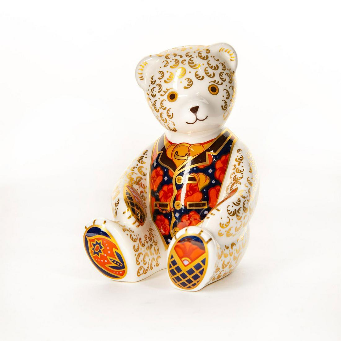 Royal Crown Derby Figural Paperweight, Teddy Bear: Beautifully decorated in a suit vest in shades of blue and orange, trimmed in gold gilt. Designed exclusively for The Royal Crown Derby Collectors Guild, marked to bottom base. Royal Crown Derby backs