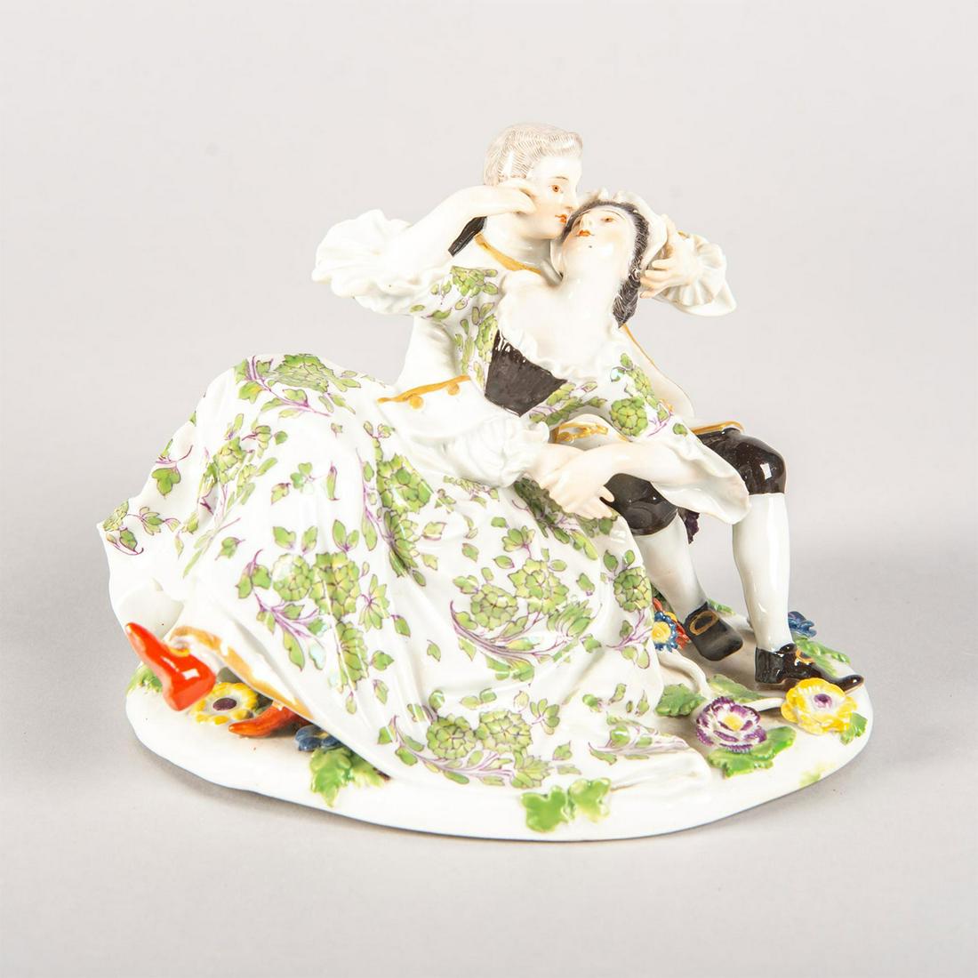 Meissen Figural Group, Courting Couple: Porcelain; painted green floral pattern; gilt highlights. Meissen's sword backstamp. Issued: 20th c. Dimensions: 4.75"H Manufacturer: Meissen Porcelain Country of Origin: Germany