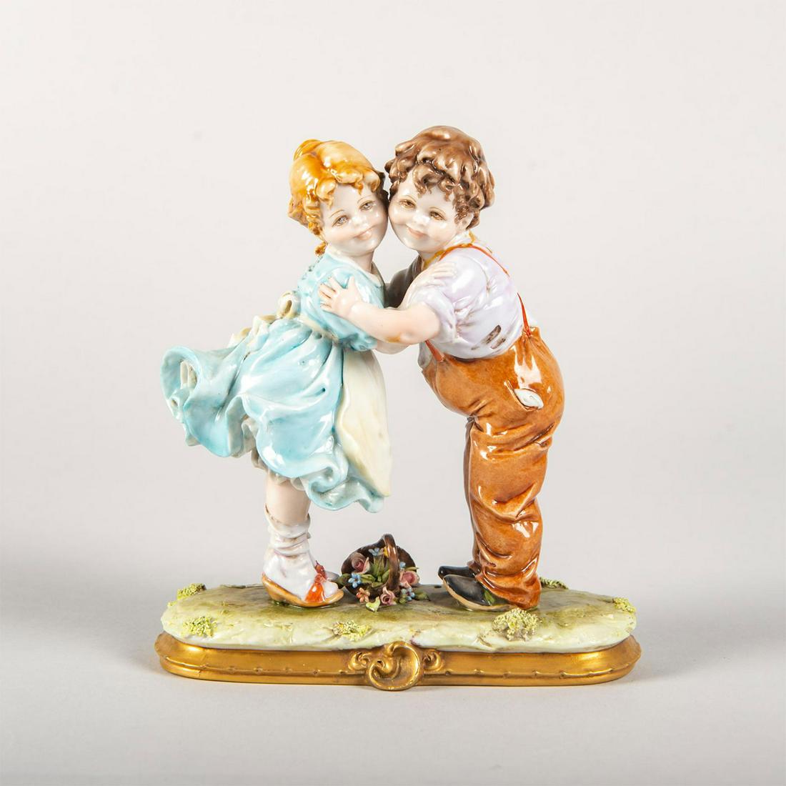 Vintage Capodimonte Kings B Merli Figurine, Children: Porcelain; young boy and girl hugging as a basket lays by there feet. Signed, B Meli. Capodimonte mark on the underside. Artist: B Merli Issued: 20th c. Dimensions: 6.75"H