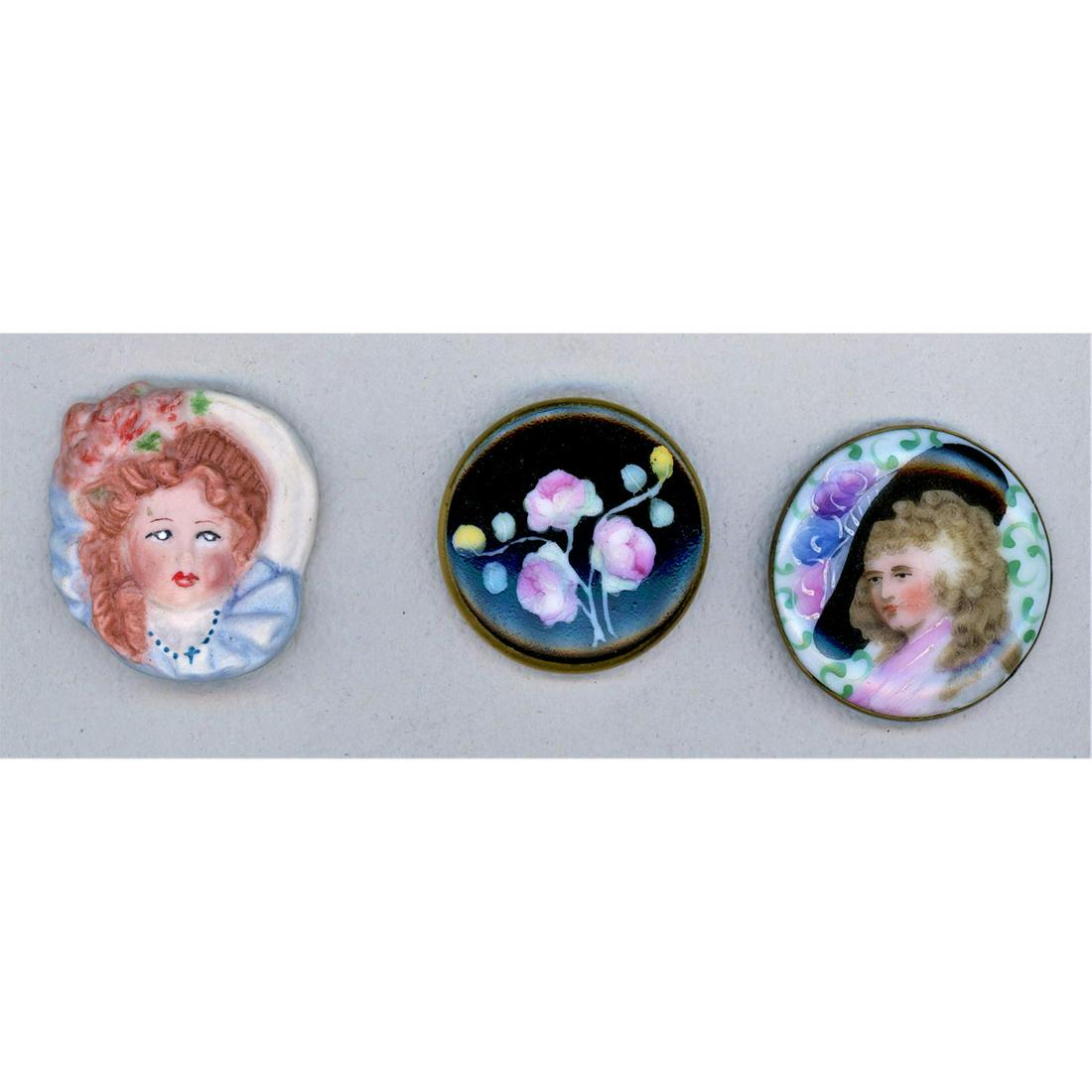 A Small Card Of Div 1 And 3 Porcelain Buttons: 3 Large hand painted porcelain buttons from the 19th & 20th C. Included is a beautiful and colorful lady in black hat set in brass from the 19th c. The other two 20th century examples are of a women a