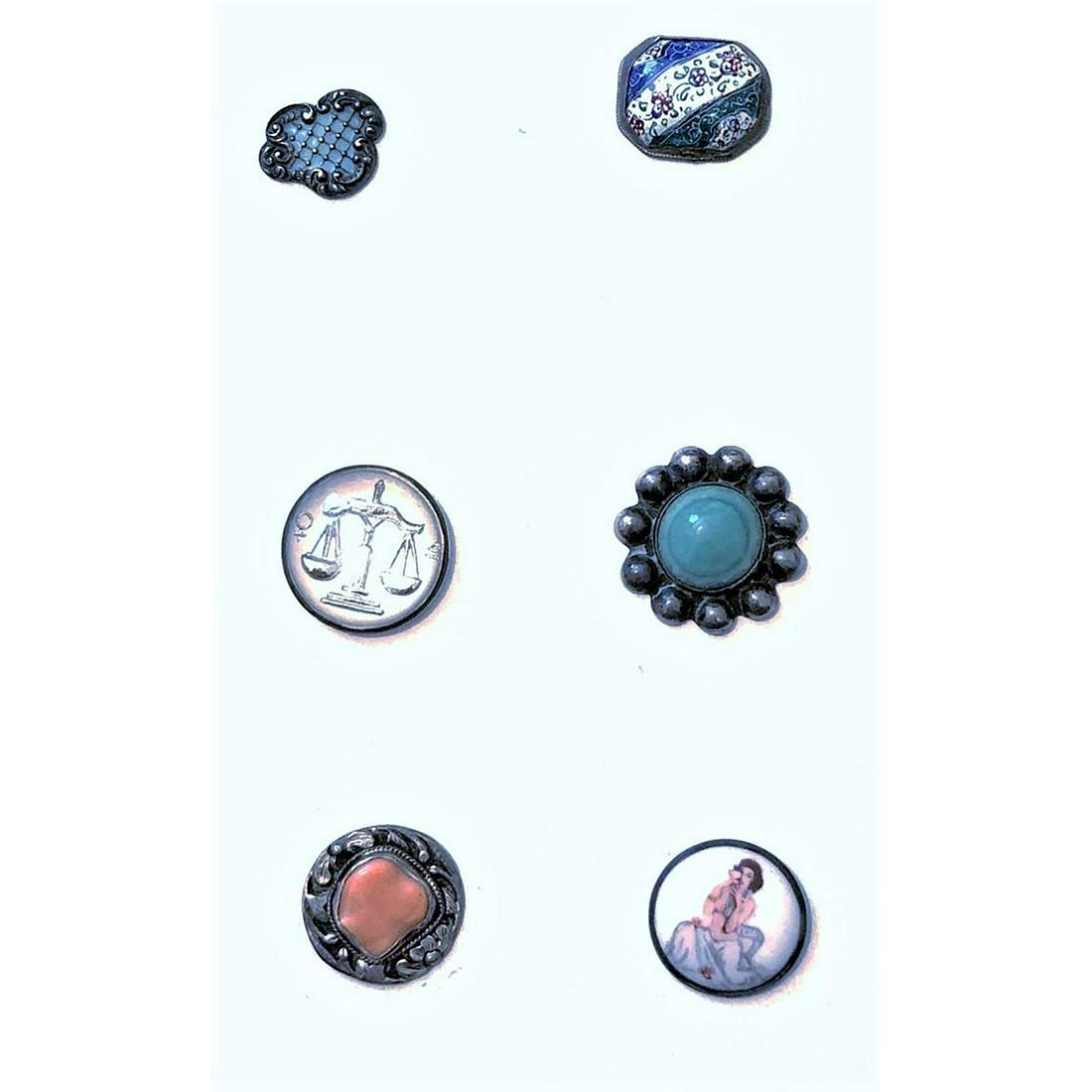A Small Card Of Assorted Materials In Metal Buttons: 6 Medium size buttons including under glass. Included in this lot is 2 enamels, a coral set in silver, a porcelain figural set in silver, a reverse intaglio glass set in metal, and Turquoise set in si