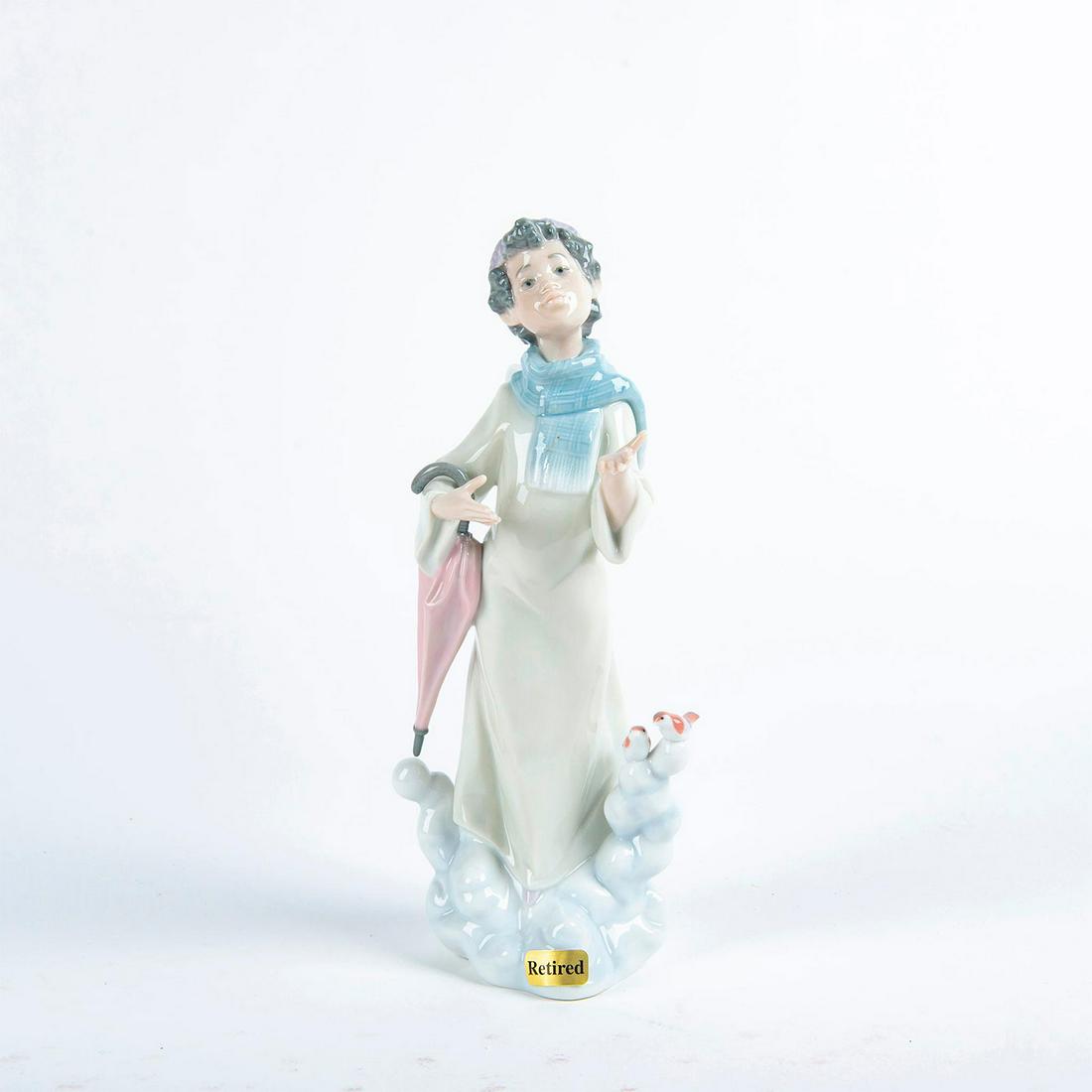Lladro Porcelain Figurine, Winter Angel 01006149: Glossy porcelain; soft green, blue and pink colorway. Lady angel with parasol. W. box. Lladro backstamp. Artist: Francisco Polope Issued: 1994 Dimensions: 11.5"H Manufacturer: Lladro Country of Origin