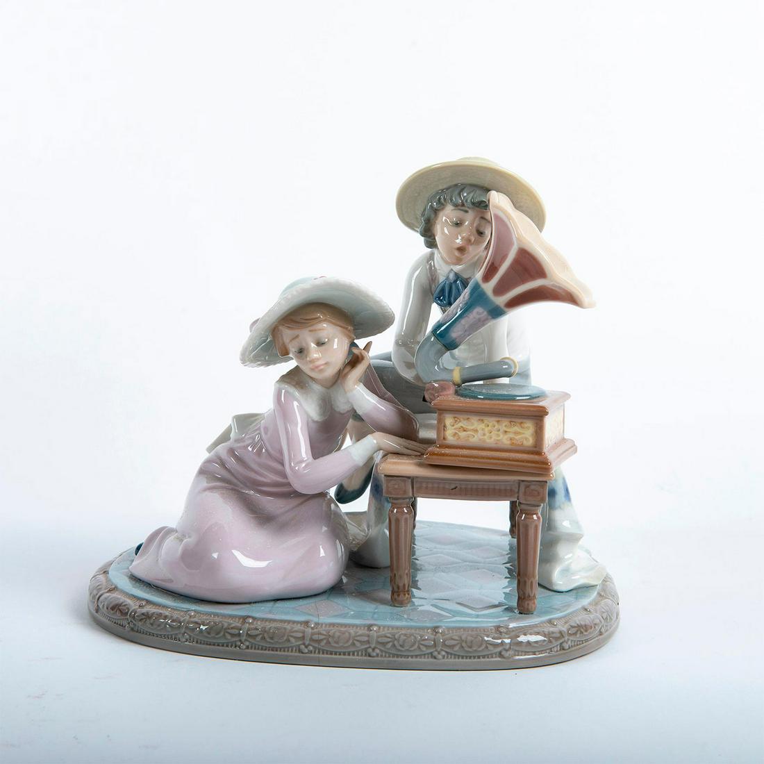 Lladro Figural Group, Music Time 01005430: Children playing a phonograph. Soft pastel coloration. Includes original box. Lladro backstamp. Artist: Regino Torrijos Issued: 1987-1989 Dimensions: 7.5"H Manufacturer: Lladro Country of Origin: Spai