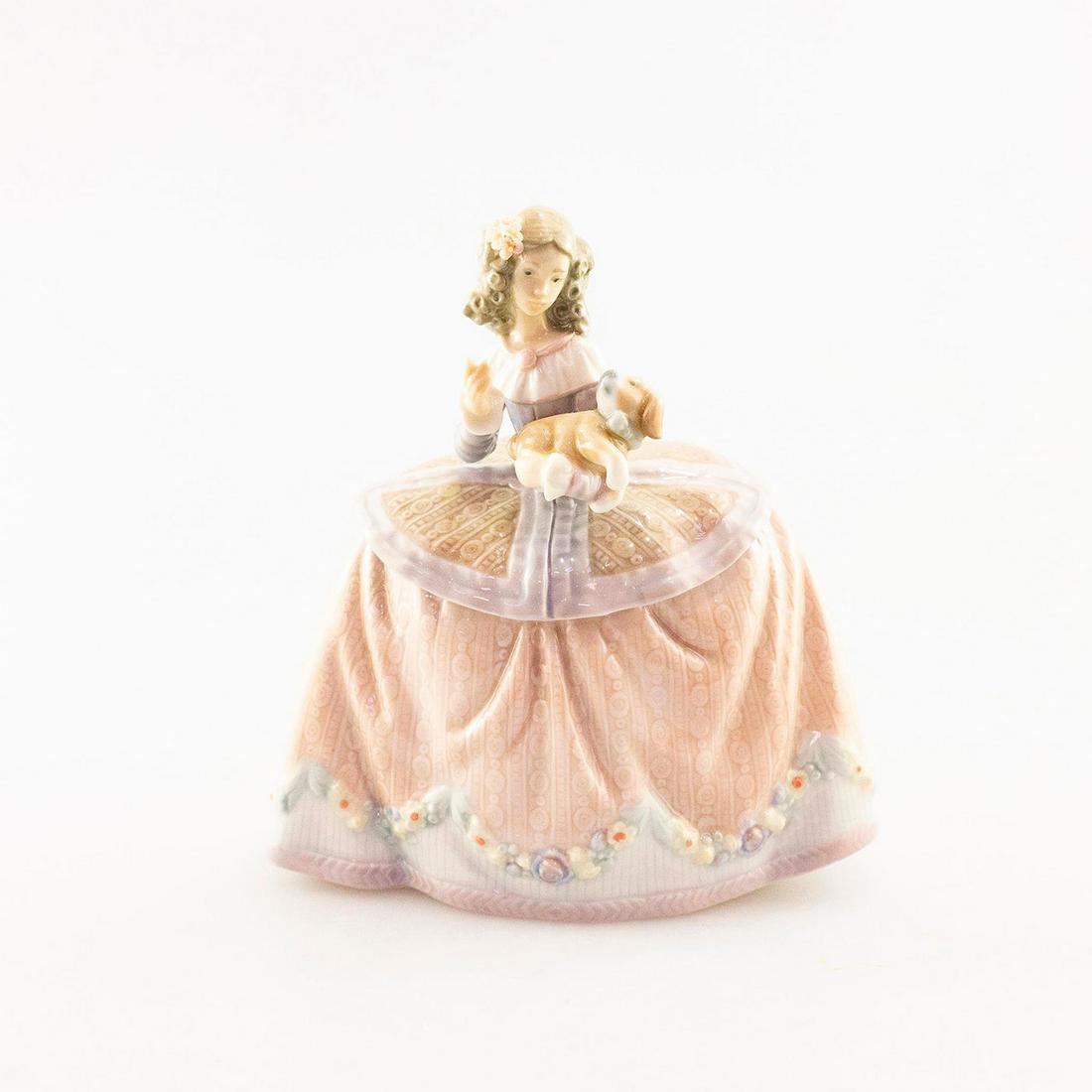 Lladro Porcelain Figurine, Pilar 01005410: Woman with dog. Porcelain; soft pink and brown coloration. Lladro backstamp. Does not include box. Artist: Jose Puche Issued: 1987 Dimensions: 6"H Manufacturer: Lladro Country of Origin: Spain Conditi