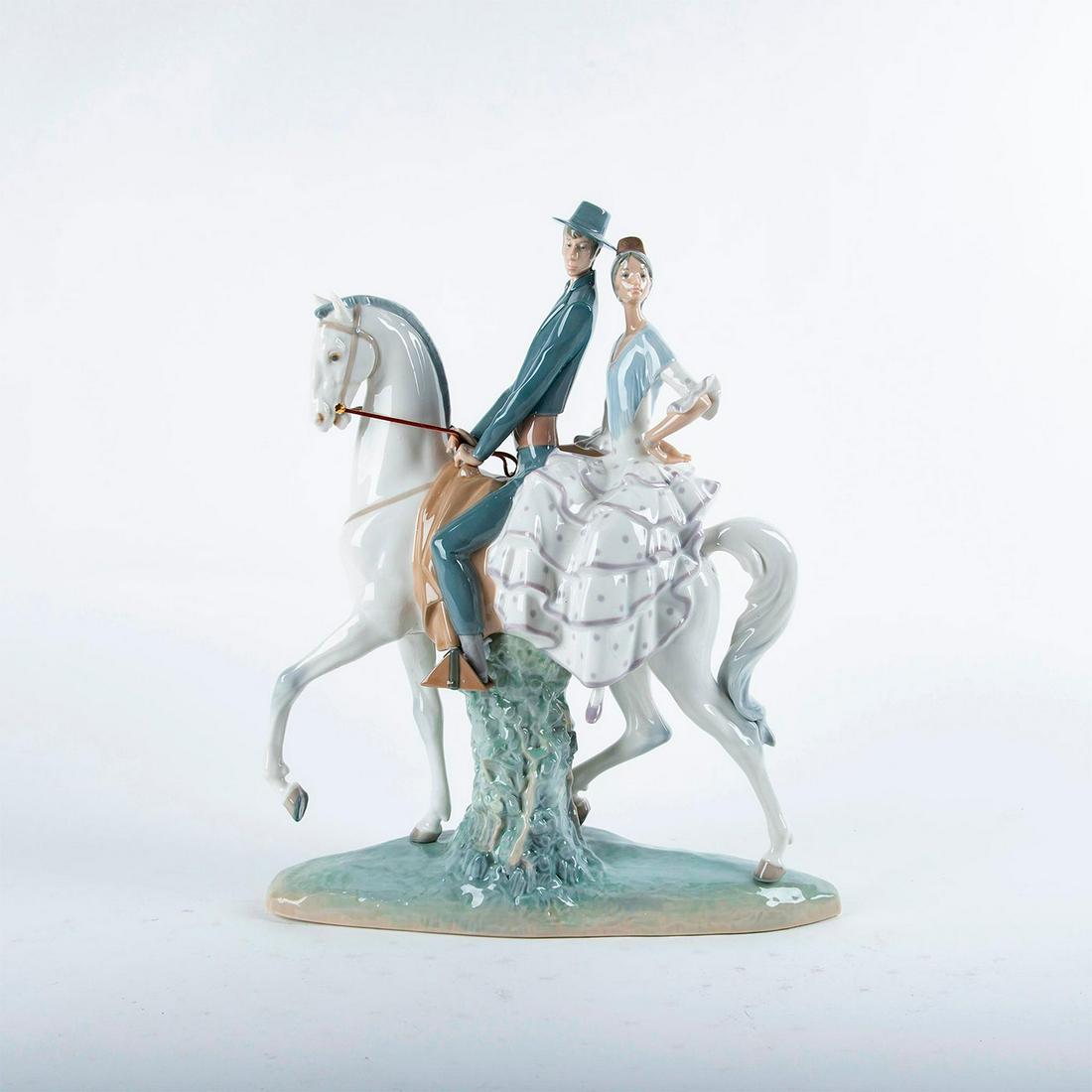 Lladro Figurine, Andalucians Group 01004647: Glossy porcelain; modeled as a couple on a white horse. Lladro backstamp. Does not include original box. Artist: Fulgencio Garcia Issued: 1969 Dimensions: 17"H Manufacturer: Lladro Country of Origin: