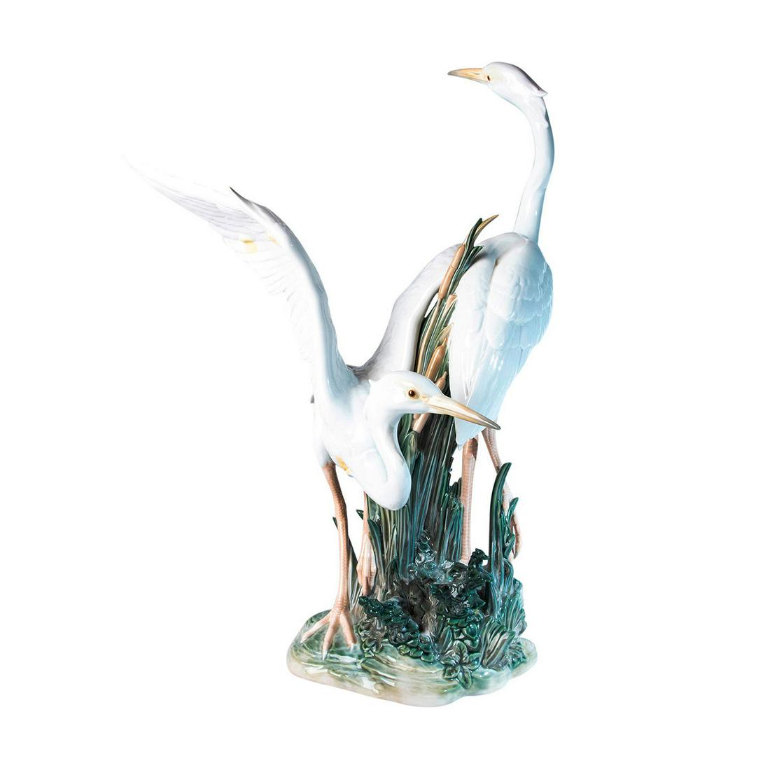 Lladro Cranes in Marsh Figure Study: Glossy large sculpture of two cranes in a marsh. Lladro backstamp. Restored foliage. Issued: 20th c. Dimensions: 22.75"H x 15.25"L Manufacturer: Lladro Country of Origin: England Provenance: David Bea