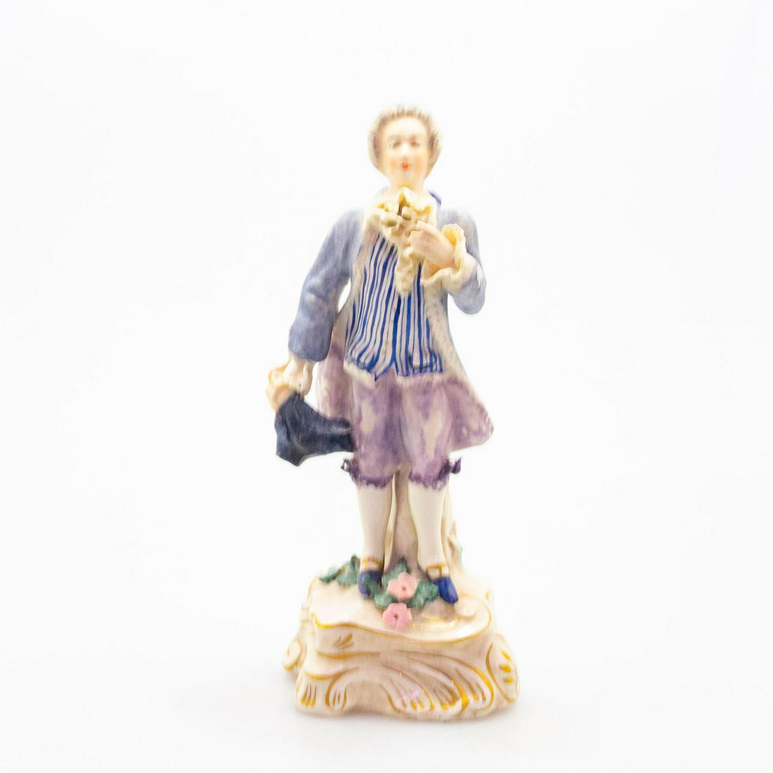 Cordey Lg Porcelain Lace Figurine, Victorian Gentlman: Hand painted in blue, purple and white; accents of gold gilt on a rococo style base. Damage to lace netting and tip to pink flower. Artist: Boleslaw Cybis Issued: c. 1940 Dimensions: 10.75"H Manufactu