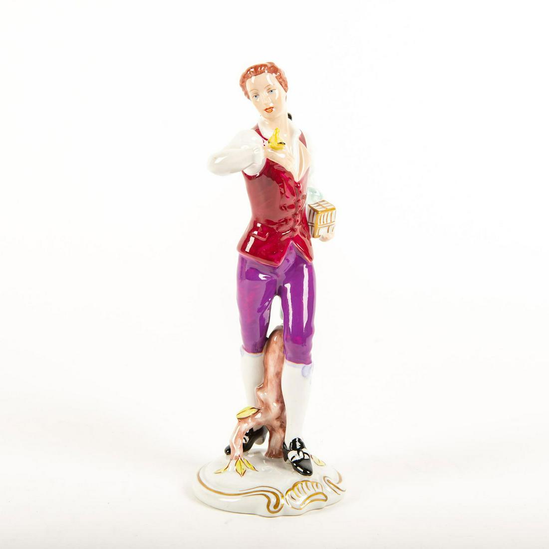 Vintage Royal Dux Bohemia Figurine, Man With Bird: Hand painted; red and purple. Man holding a bird cage with a bird perched on right hand. Rests on circular base; gilt highlights. Issued: 20th c. Dimensions: 10.5"H Manufacturer: Royal Dux Bohemia Cou