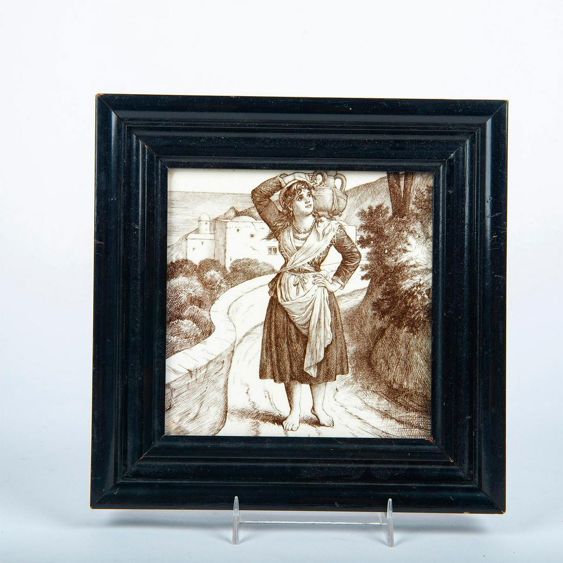 Minton William Wise Transferware Tile, Girl With Jug,: Country Life. Ceramic; transfer printed brown against an earthenware brown ground. Woman carrying jug on shoulder. Marked Minton on the underside. Housed in black wooden frame. Tile shown, 6"L x 6"W. 