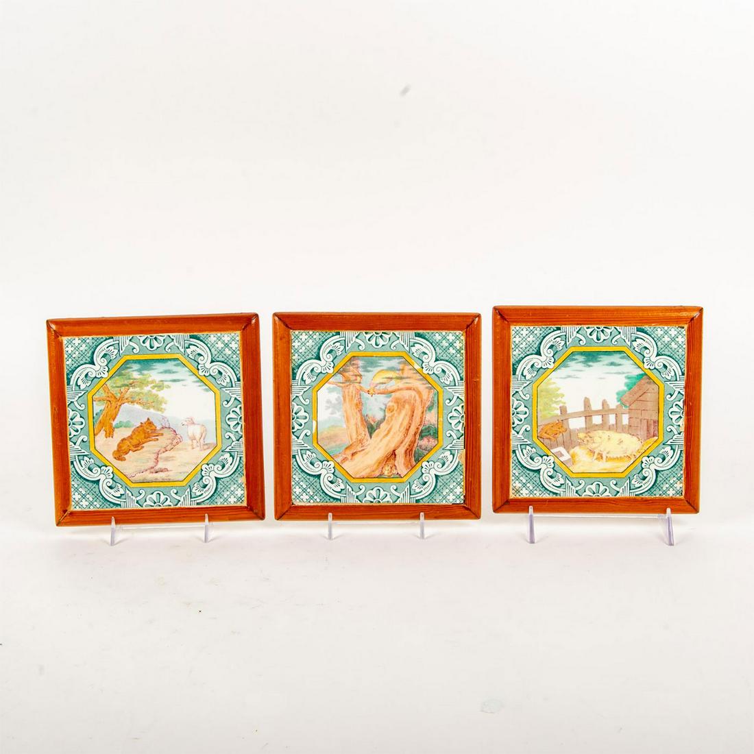3 Minton Ceramic Fable Pictorial Tiles, Wolf Hunt: Polychrome decorative tiles; wolf and sheep, wolf and pig and wolf with rooster. All piece enclosed in brown frame. Minton backstamps. Age related wear. Issued: 20th .c Dimensions: 7.25"L x 7.25"W Man