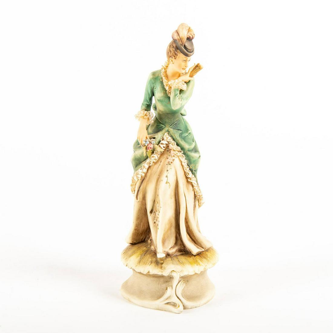 A. Borsato Bisque Porcelain Figurine, Lady With Pink: Hand painted, depicting a lady in a green, soft lace trimmed dress holding a pink rose and a hand fan. Impressed Original A. Borsato Made Italy to backside of base. Original paper label to bottom base