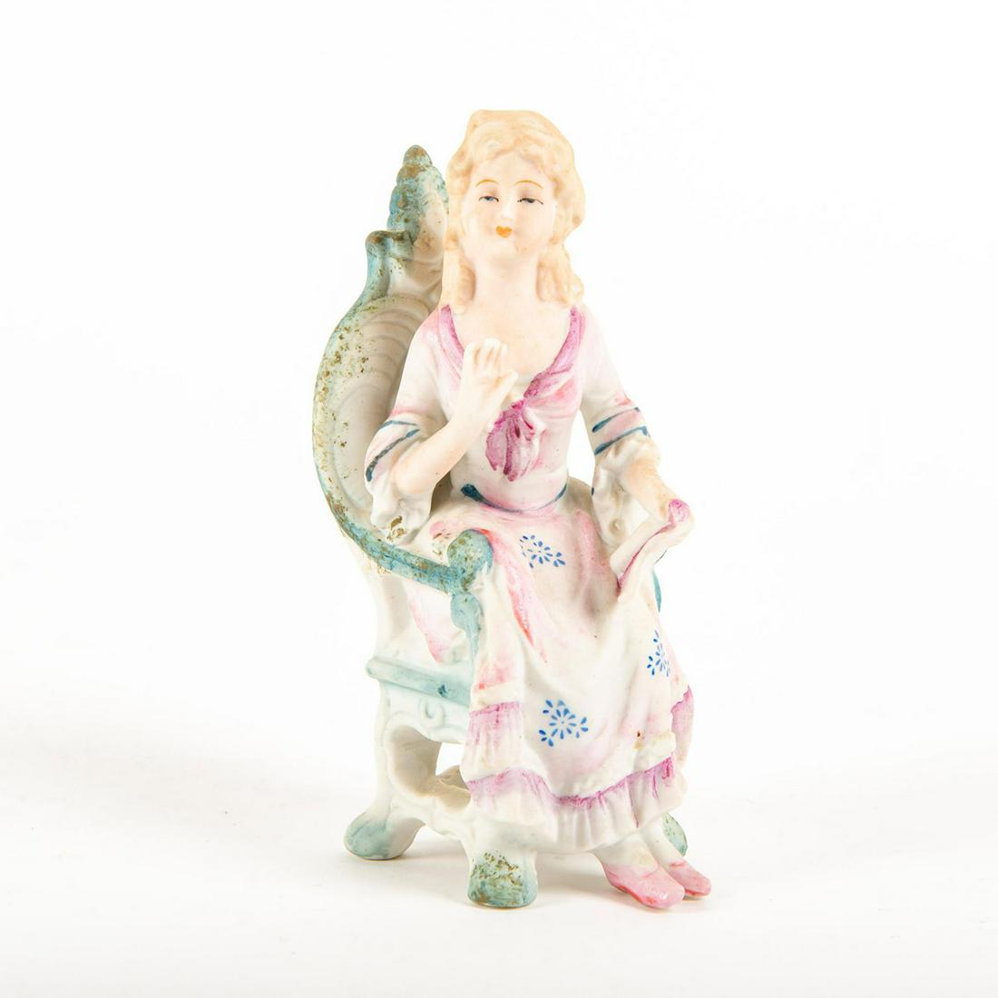 Fern Japanese Ceramic Figurine, Seated Lady: Hand painted, depicting a seated lady in pink with book in hand; matte finish. Impressed Copyright c. L& Minc to backside of chair. Issued: 20th c. Dimensions: 6"H Manufacturer: L & Minc Country of Or