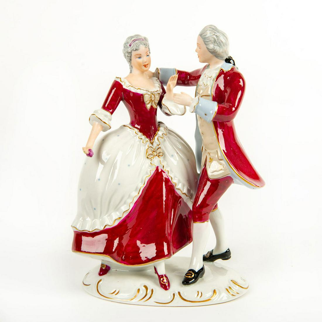 Royal Dux Bohemia Figurine, Couple Dancing: Hand painted; red and white colorway with gilt highlights. Rests on oval base. Royal Dux Bohemia backstamp. Issued: 20th c. Dimensions: 9"H Manufacturer: Royal Dux Bohemia Country of Origin: Czechoslo