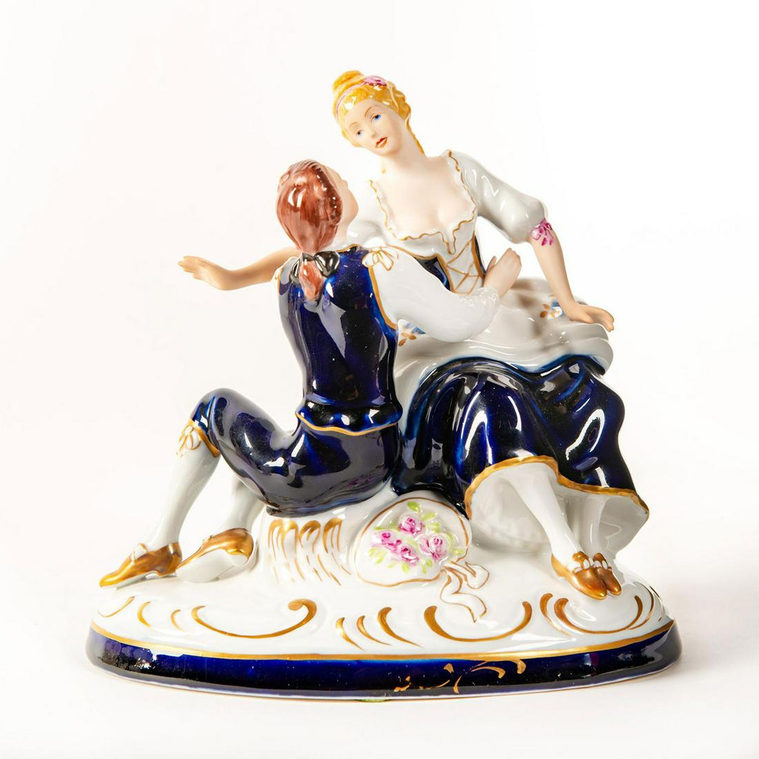 Royal Dux Bohemia Figure Group, Courting Couple: Hand painted; cobalt blue and white; pink and gilt accents. Rests on oval base. Royal Dux backstamp. Issued: 20th c. Dimensions: 7.5"H Manufacturer: Royal Dux Bohemia Country of Origin: Czechoslovakia