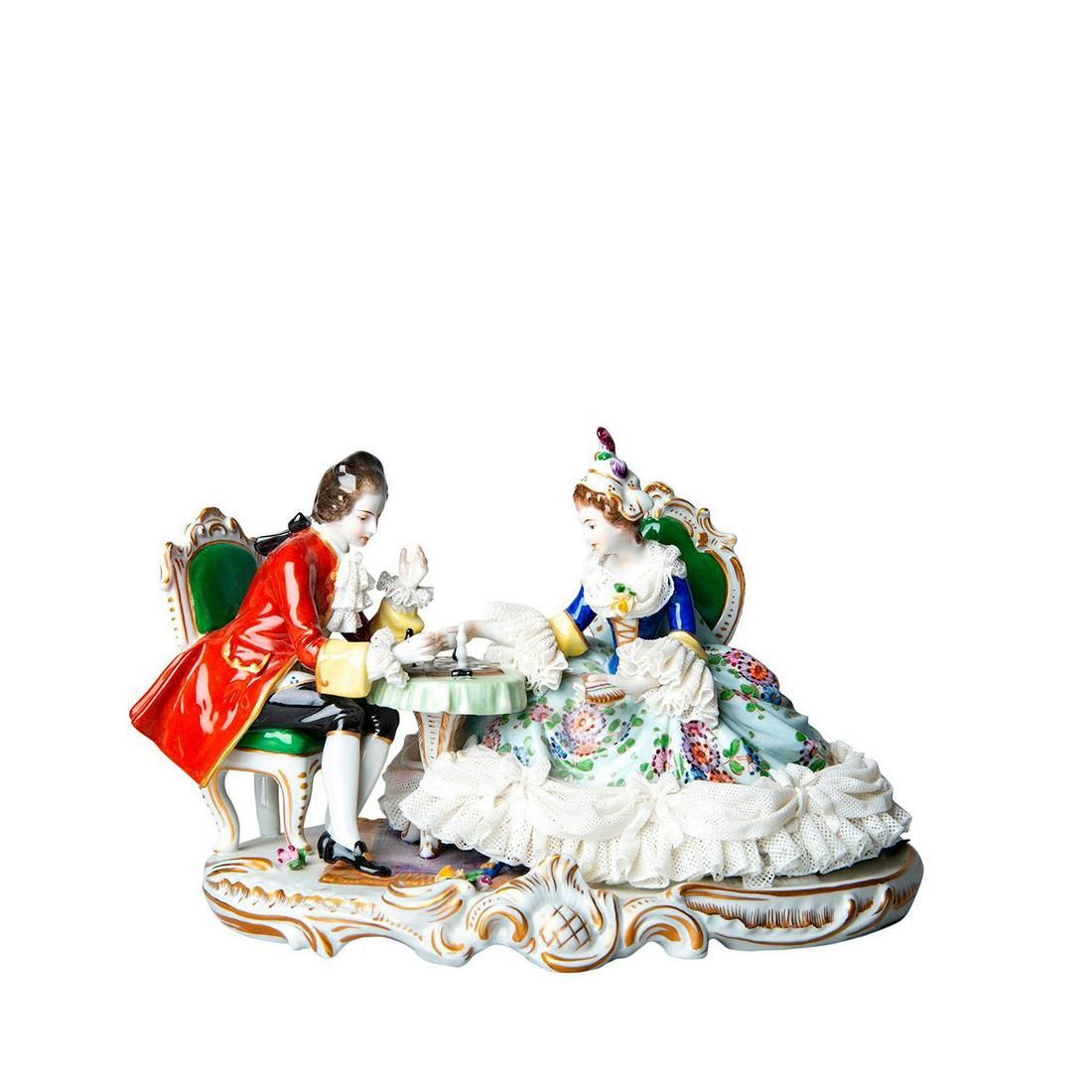 Volkstadt Lace Figurine Study Of Gentleman And Lady: Depicts a Victorian couple playing chess on Rococo style base accented with gold gilt. Volkstadt blue mark to top, back base. Small damage to lace netting. Issued: 20th c. Dimensions: 6.5"H Manufactur