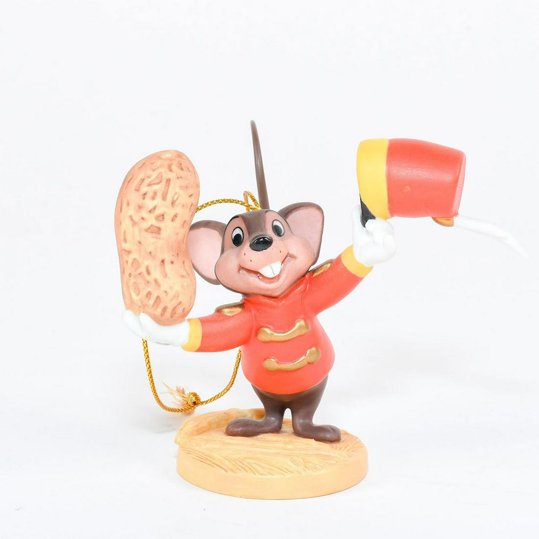 Disney Classics Ornament, Timothy Mouse, Dumbo: Timothy Mouse tips his hat while holding shelled peanuts. Ceramic figure of Timothy Mouse from the film 'Dumbo'. Gilt decoration on hat and jacket. Metal tail. #disney