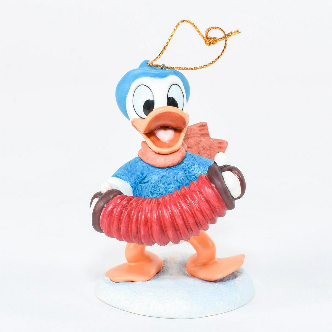 Disney Ornament, Donald Duck, Pluto's Christmas Tree: Donald Duck stands in festive winter attire playing the accordion. Ceramic ornament with quote on bottom "Fa la la...". #disney