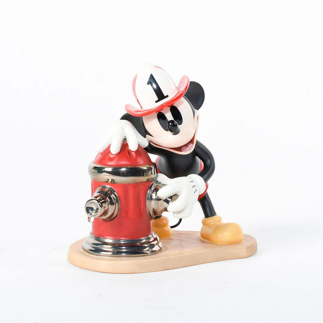 Disney Classic Figurine, Mickey Mouse, Mickey's Fire: Mickey stands adjusting a fire hydrant while a drop of water escapes. Ceramic figure from the Disney film 'Mickey's Fire Brigade'. A clear resin water droplet drips from the fire hydrant, which is hig