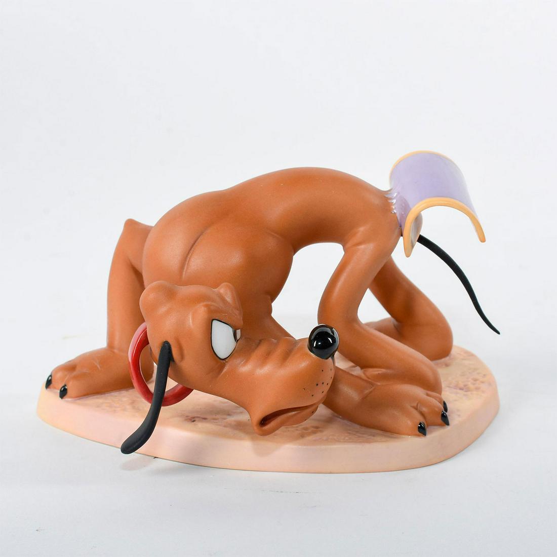 Disney Classics Collection Figurine, Pluto, Sticky: Pluto glares angrily at the sticky flypaper stuck to his tail. Ceramic figure, from the 1939 Disney short film 'Beach Picnic' featuring Donald Duck and Pluto. #disney