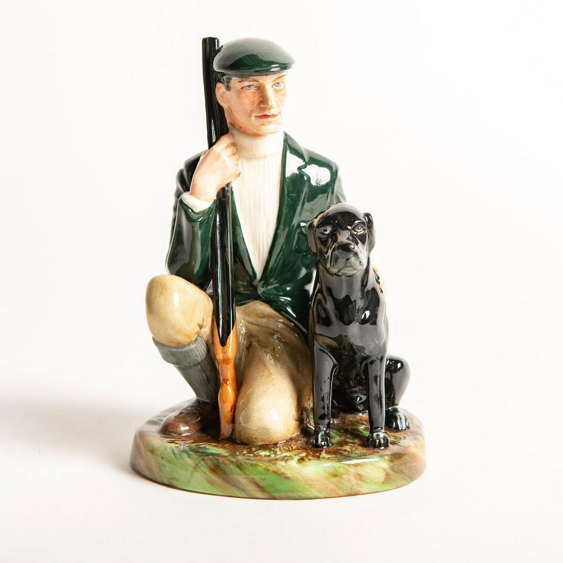 Royal Doulton Figurine, Gamekeeper HN2879: Modeled as a man hunting with his black labrador retriever dog. Royal Doulton backstamp. Artist: Eric J. Griffiths Issued: 1984 - 1992 Dimensions: 7.25"H Manufacturer: Royal Doulton Country of Origin: