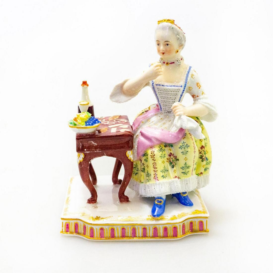 German Porcelain Figurine, Sense of Taste: Hand painted in style of Meissen after Johann Carl Schoenheit (1730-1805). On square base, decorated in gold gilt and pink ornaments. Bottom base impressed with shield, F, 845 and blue PM&M DKF mark. 