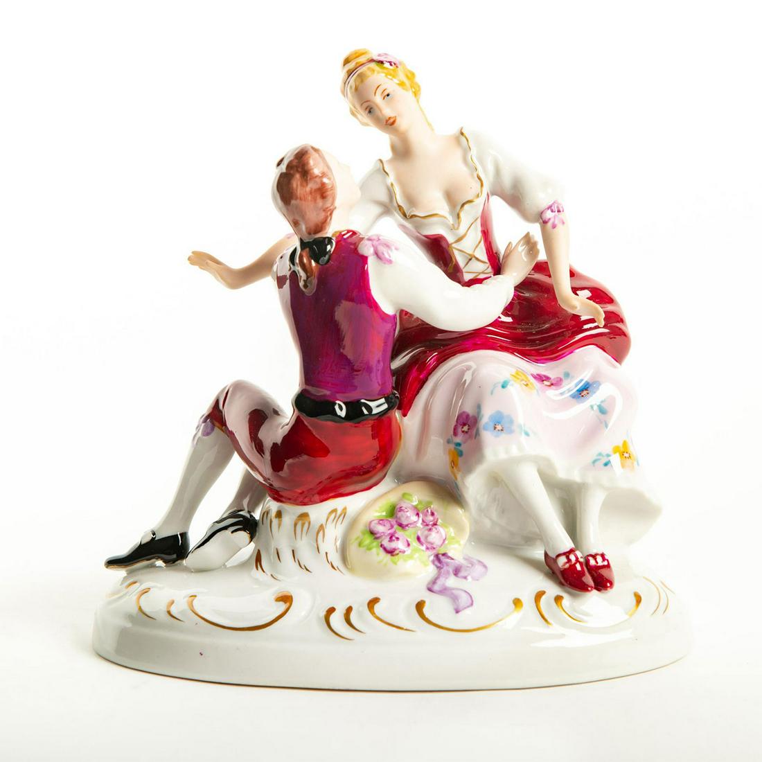 Royal Dux Bohemia Figurine, Courting Couple: Red, white and pink colorway; floral detail; gilt highlights. Royal Dux backstamp. Issued: 20th c. Dimensions: 7.5"H Manufacturer: Royal Dux Bohemia Country of Origin: Czechoslovakia
