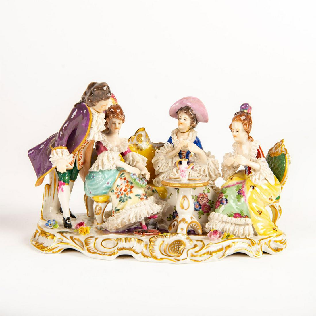 Volkstedt Figural Group, Tea Time: Tea party scene. Hand painted; porcelain lace detail; gilt highlights. Volkstedt backstamp. Issued: 20th c. Dimensions: 7.5"L Manufacturer: Volkstedt Country of Origin: Germany