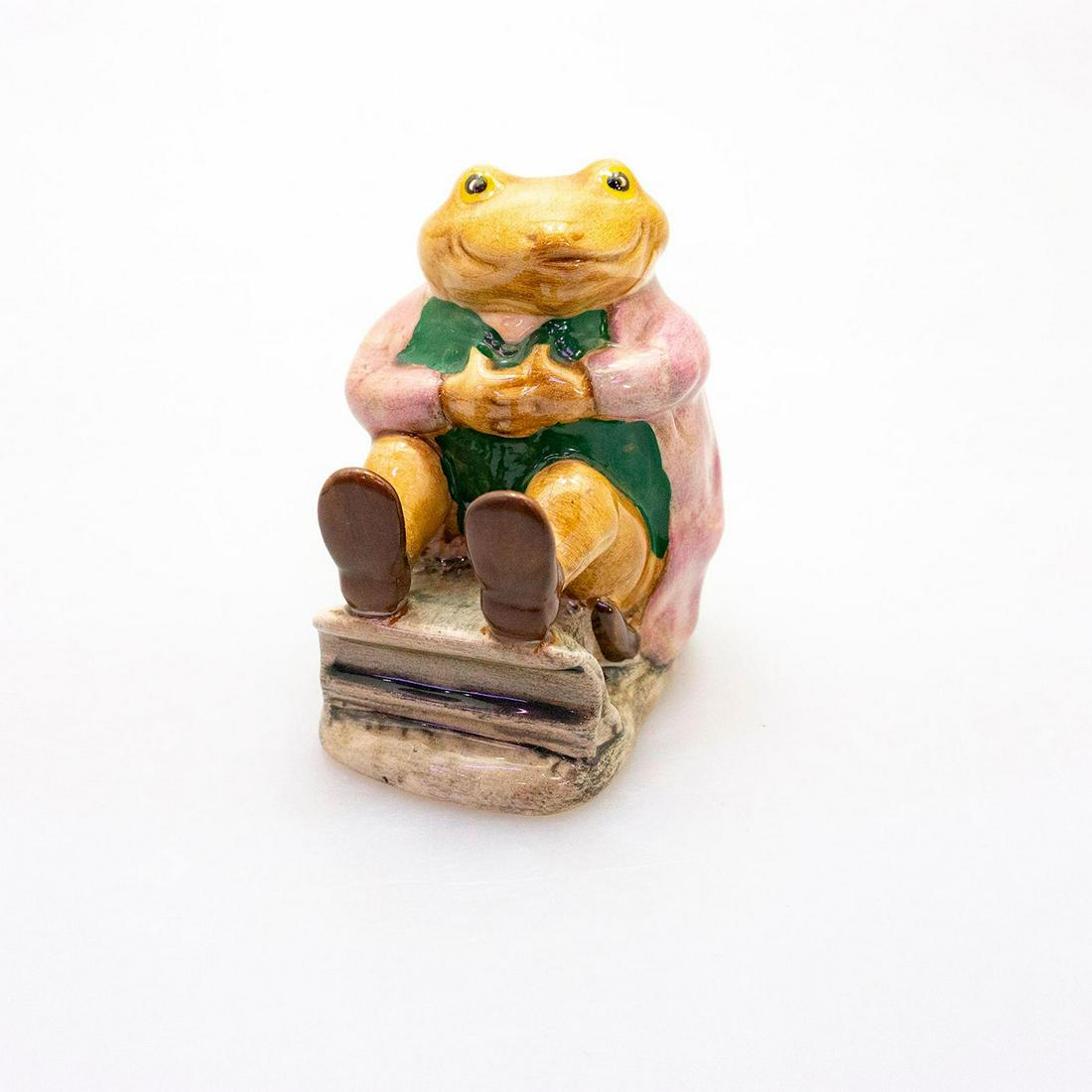 Royal Albert Beatrix Potter Figurine, Mr Jackson: Modeled as a brown toad wearing a mauve jacket. Royal Albert backstamp. Artist: Albert Hallam Issued: 1975 - 1997 Dimensions: 2.75"H Manufacturer: Royal Albert Country of Origin: England