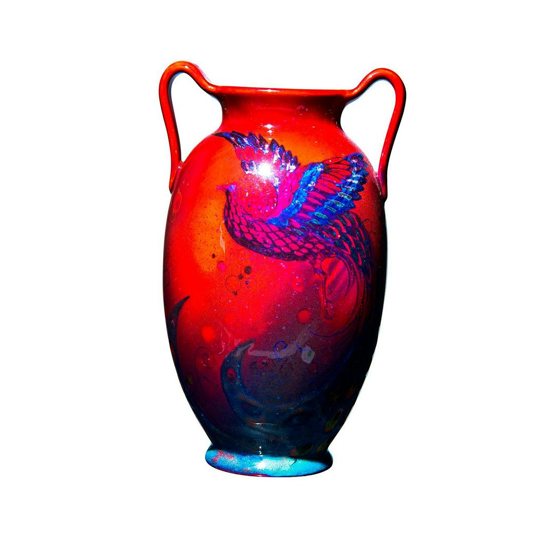 Royal Doulton Sung Flambe Twin Handled Vase, Firebird: Stunning scene of firebird flying with full elongated tail. Signed A. Maxfield. Red and blue, high fired glaze. Doulton Sung backstamp. Artist: A. Maxfield Dimensions: 6.5"H x 4"W x 2.5"D Manufacturer