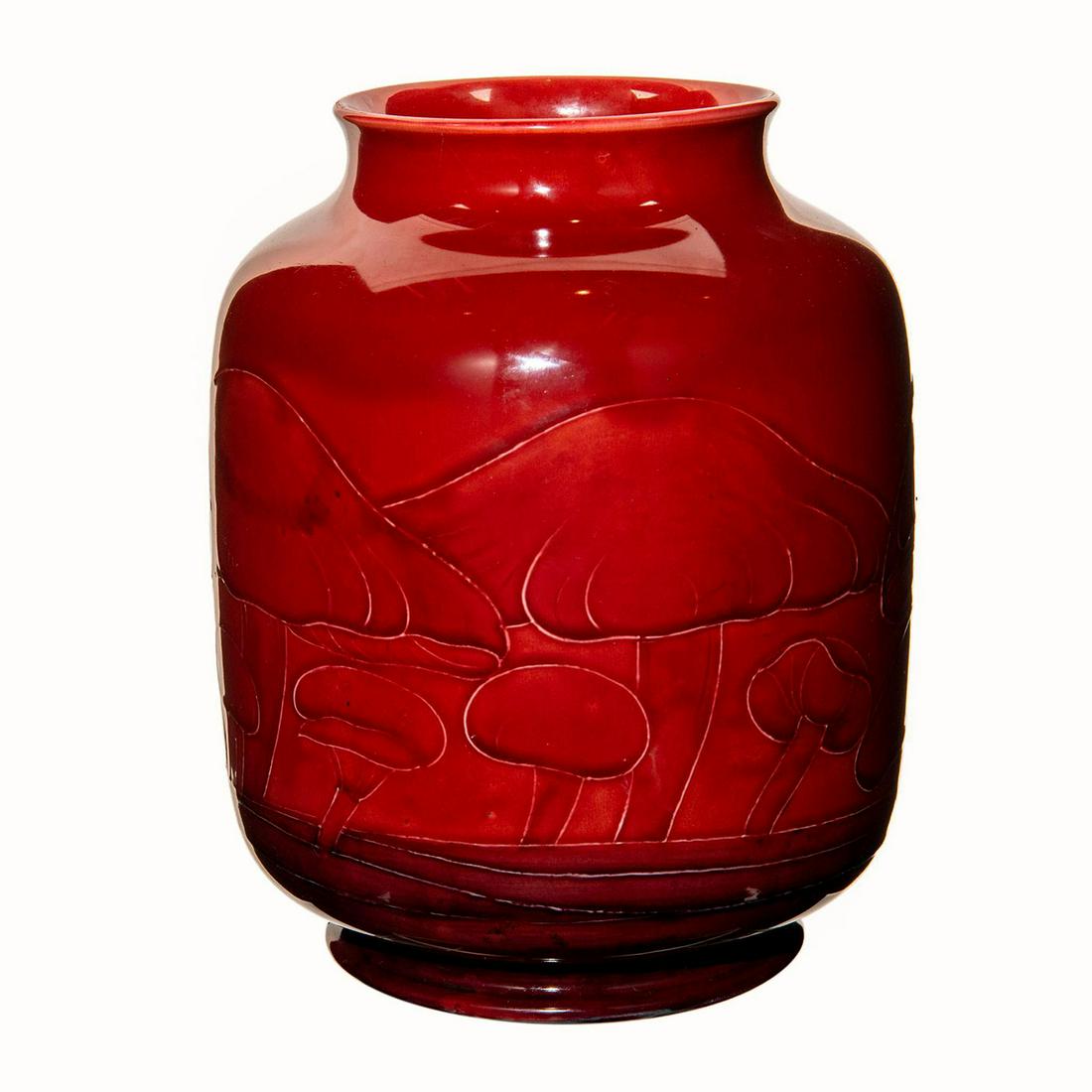 Moorcroft Claremont Pattern Flambe Vase: Decorated with tubelined toadstool against red ground accented in purple coloration. Artist signature to bottom base. Artist: William Moorcroft Issued: c. 1925 Dimensions: 8.75"H Manufacturer: Moorcro