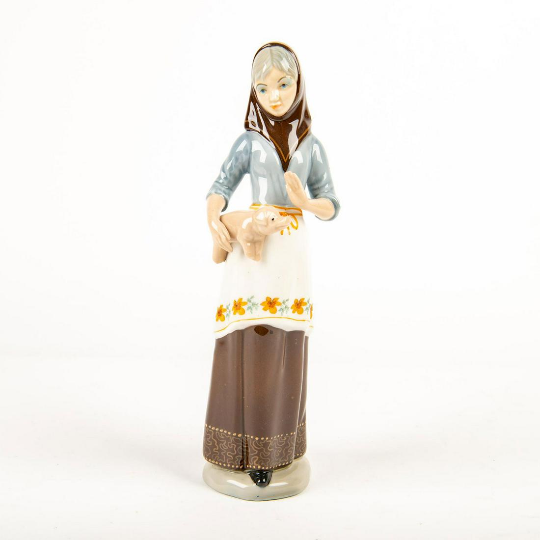 GAMA Porcelain Figurine, Woman with Piglet: Glossy porcelain of a country woman with a piglet in her arm. GAMA backstamp