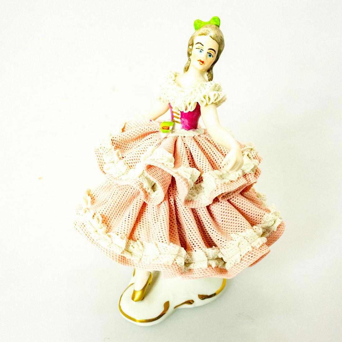 Wilhelm Rittirsch Lady Figurine, Ballerina: Lady dancer. Pink and white lace gown; gilt highlights. Wilhelm Rittirsch backstamp. Chip to lace. Issued: 20th c. Dimensions: 5.5"H Manufacturer: Wilhelm Rittirsch Country of Origin: Germany