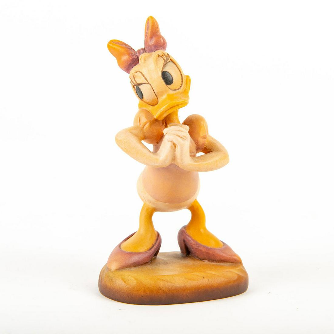 ANRI Woodcarving, Daisy: Woodcarved figurine of Disney's Daisy. Edition #603 of 5000. ANRI metal emblem under base. Limited edition #603 of 5000. Dimensions: 4"H Edition Number: 603 of 5000 Manufacturer: Anri Country of Origi