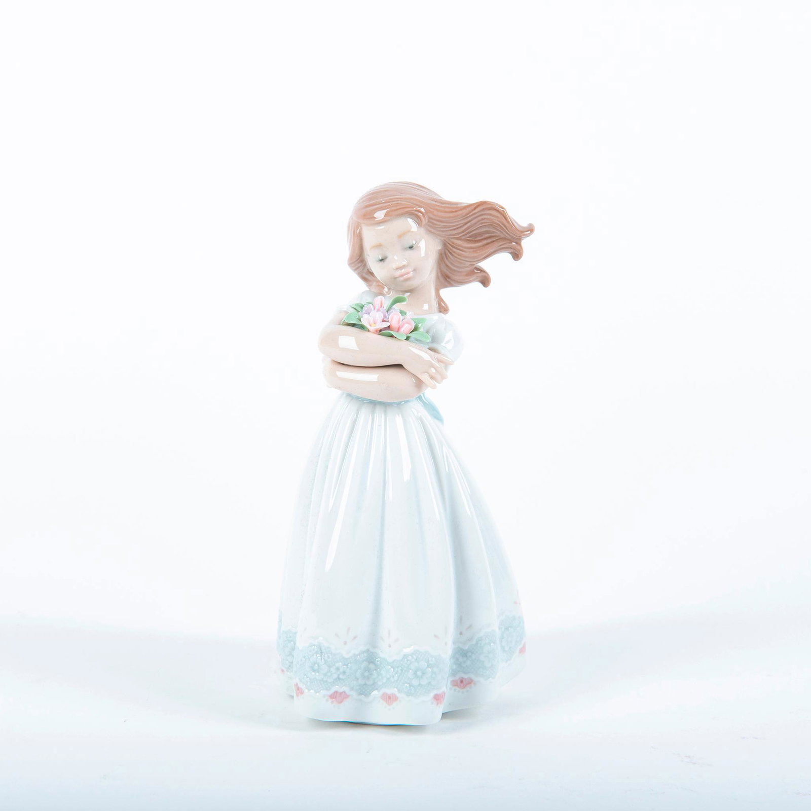 Tender Innocence 1008248 - Lladro Porcelain Figure: A dainty girl in a gown with a floral border holds a bunch of flowers. Includes original box #lladro Artist: Jose Javier Malavia Issued: 2006 Dimensions: 7"H Manufacturer: Lladro Country of Origin: Sp