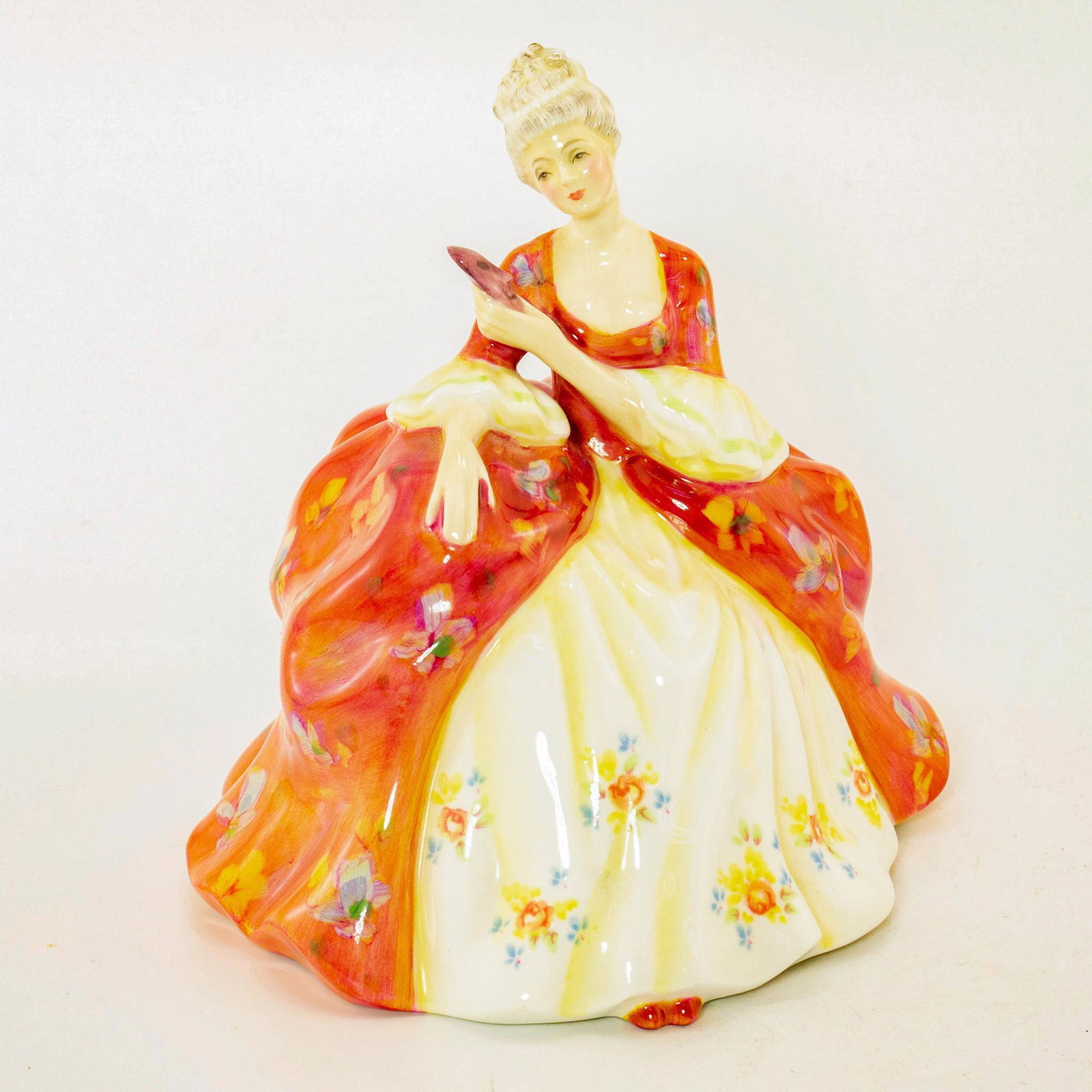 Wistful HN2396 - Royal Doulton Figurine: Peggy Davies Classics. Peach and cream coloration. Doulton backstamp. Artist: Peggy Davies Issued: 1979-1990 Dimensions: 7"H Manufacturer: Royal Doulton Country of Origin: England