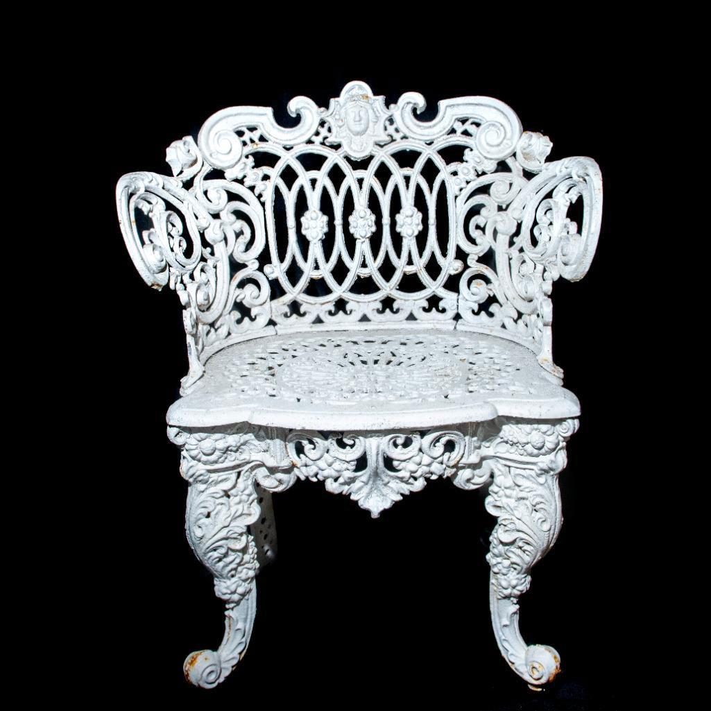 Renaissance Revival Style Cast Aluminum Garden Chair: Figural garden chair; scroll and foliate design with head. Pierced seat and raised foliate. Cabriole legs terminating in scroll feet. Age and use related wear. Issued: 20th c. Dimensions: 32.5"L x 25"