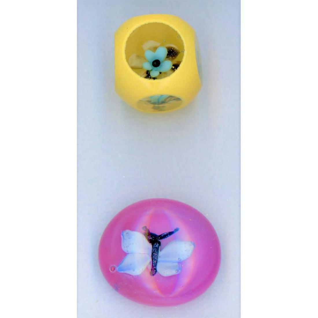 TWO DIVISION THREE GLASS PAPERWEIGHT BUTTONS.: 2 20th century paperweight buttons including faceted. The yellow g=faceted overlay window example is very tall. The other example on a ping base has a beautiful butterfly cane. Dimensions: SM=Less tha