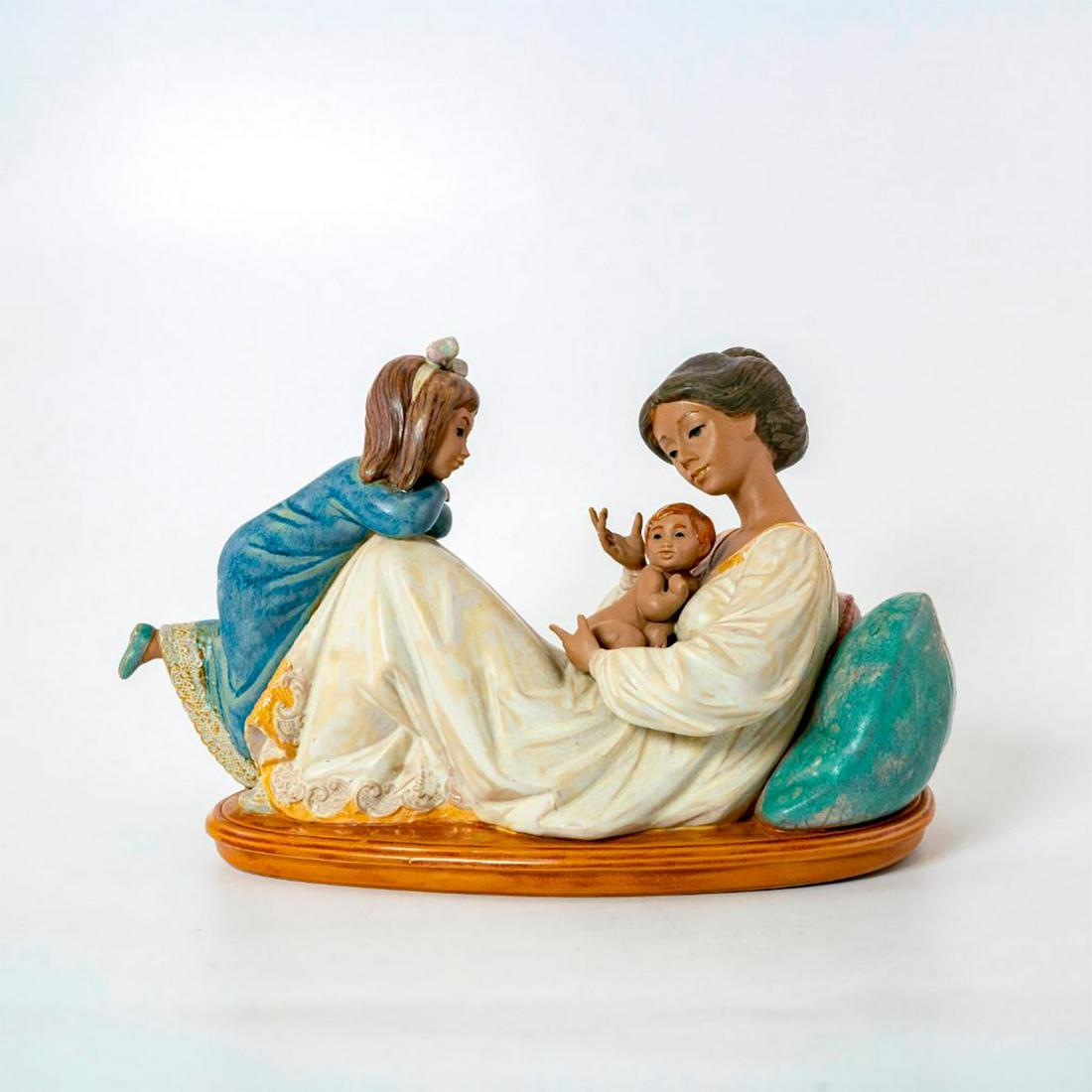 Latest Addition 1012262 - Lladro Porcelain Figure: Gres finish; Young woman with daughter and new baby. With original box. Lladro backstamp. Artist: Jose Puche Issued: 1989-1998 Dimensions: 6.25"H x 10.75"W