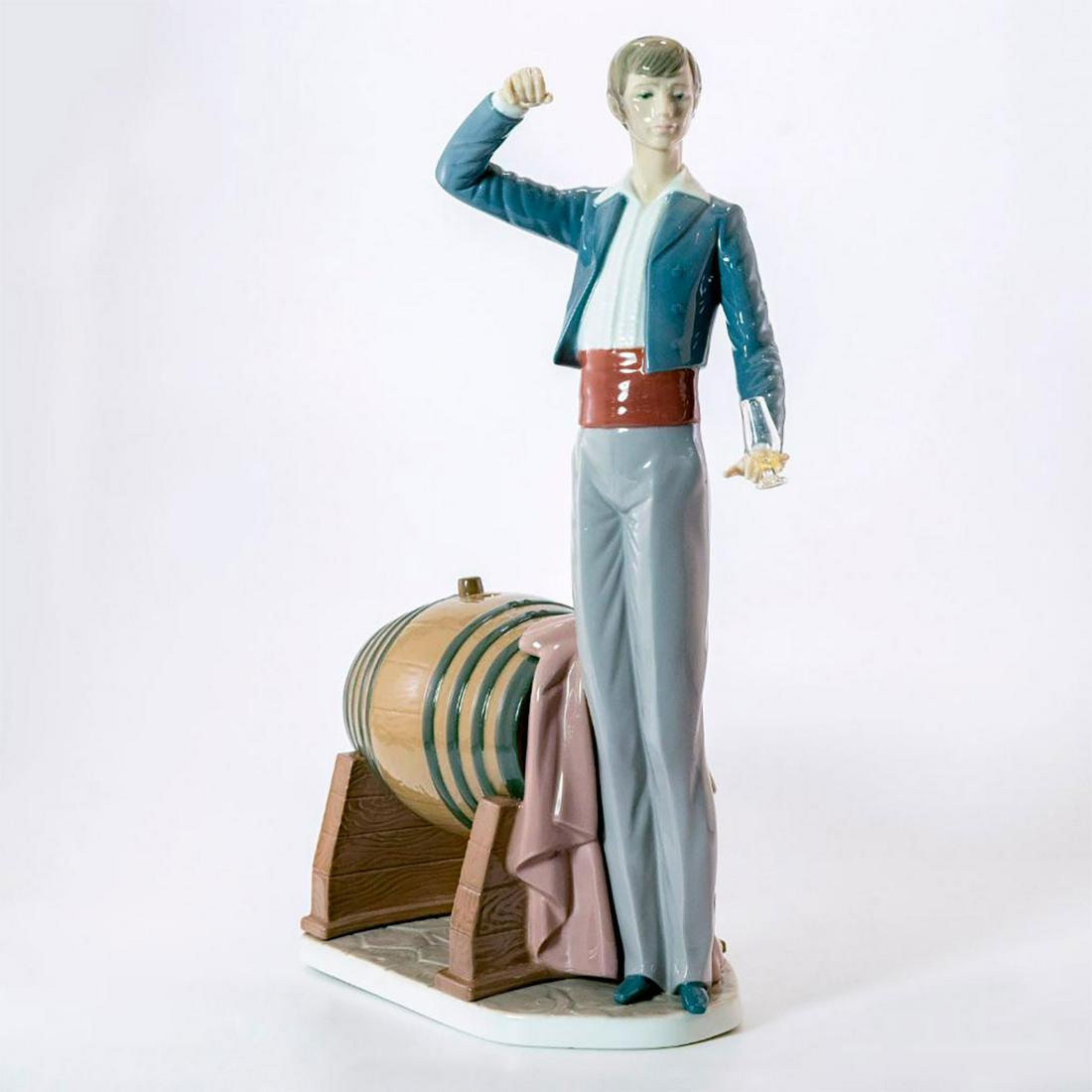 Wine Taster 1005239 - Lladro Porcelain Figure: Glazed; Man standing next to barrel with wine glass and staff. With box, no sticker. Lladro backstamp. Artist: Francisco Catala Issued: 1984-2002 Dimensions: 14.5"H x 11"W