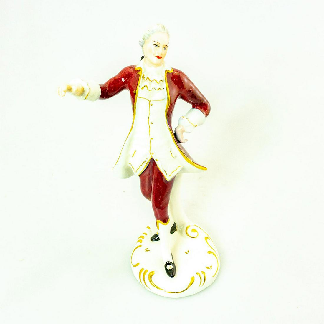 Royal Dux Figurine, Male Dancer: Porcelain; red, white coloration with gilt highlights. Colonial style figure. Royal Dux backstamp. Issued: 20th c. Dimensions: 8.75"H Manufacturer: Royal Dux Country of Origin: Czechoslovakia
