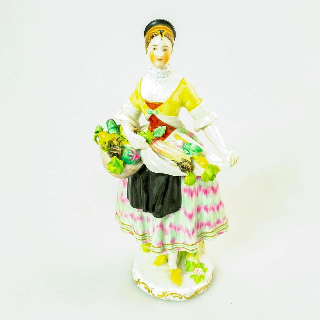 Vintage Augarten Wien Vienna Figurine, Fruit Vendor: Hand painted porcelain; glazed. Woman with basket of vegetables for sale. Wien backstamp. Broken basket handle. Issued: 20th c. Dimensions: 8"H Manufacturer: Augarten Wien Country of Origin: Austria