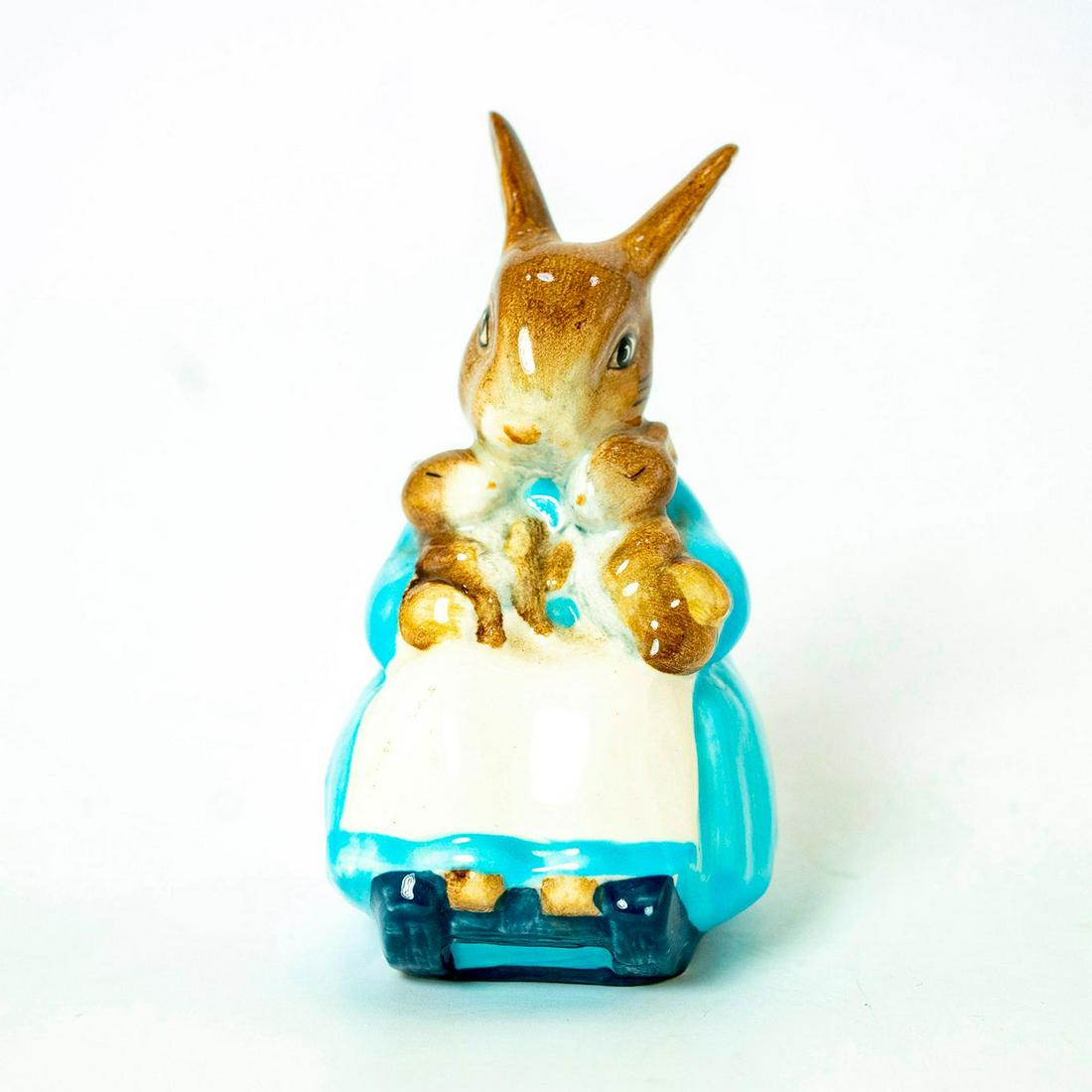 Mrs. Rabbit and Bunnies - Beswick - Beatrix Potter: Beswick Backstamp. Blue dress with white apron, dark blue chair. Artist: David Lyttleton Issued: 1976 - 1997 Dimensions: 3.75''H Country of Origin: England Manufacturer: Beswick