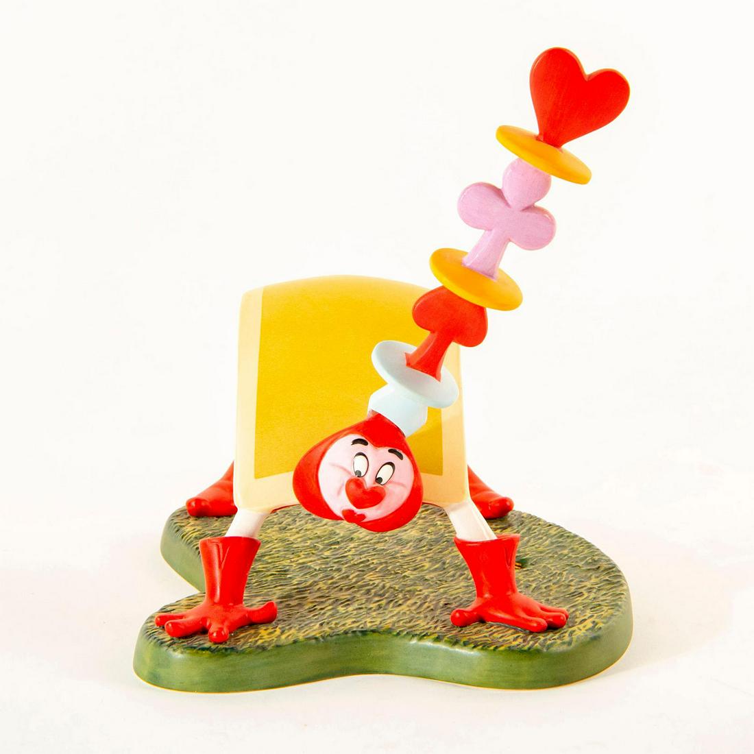 Disney Figurine, Playing Card From Alice and Wonderland: Matte finished figurine; Playing card; bent over; red and green. With Box Certificate Included. Chip on hat Dimensions: 4"H Country of Origin: Taiwan Manufacturer: Disney Condition: Broken Headpiece