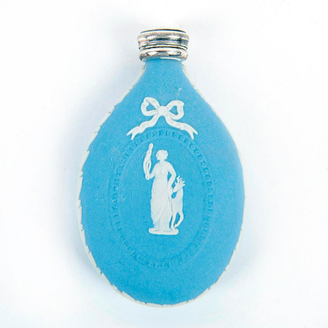 Vintage Wedgwood Blue Jasperware Perfume Bottle: Matte, blue ground with white bas-relief figure of a woman; foliate borders; hallmarked silver cap. Wedgwood backstamp. Issued: 20th c. Dimensions: 3"H Manufacturer: Wedgwood Country of Origin: Englan