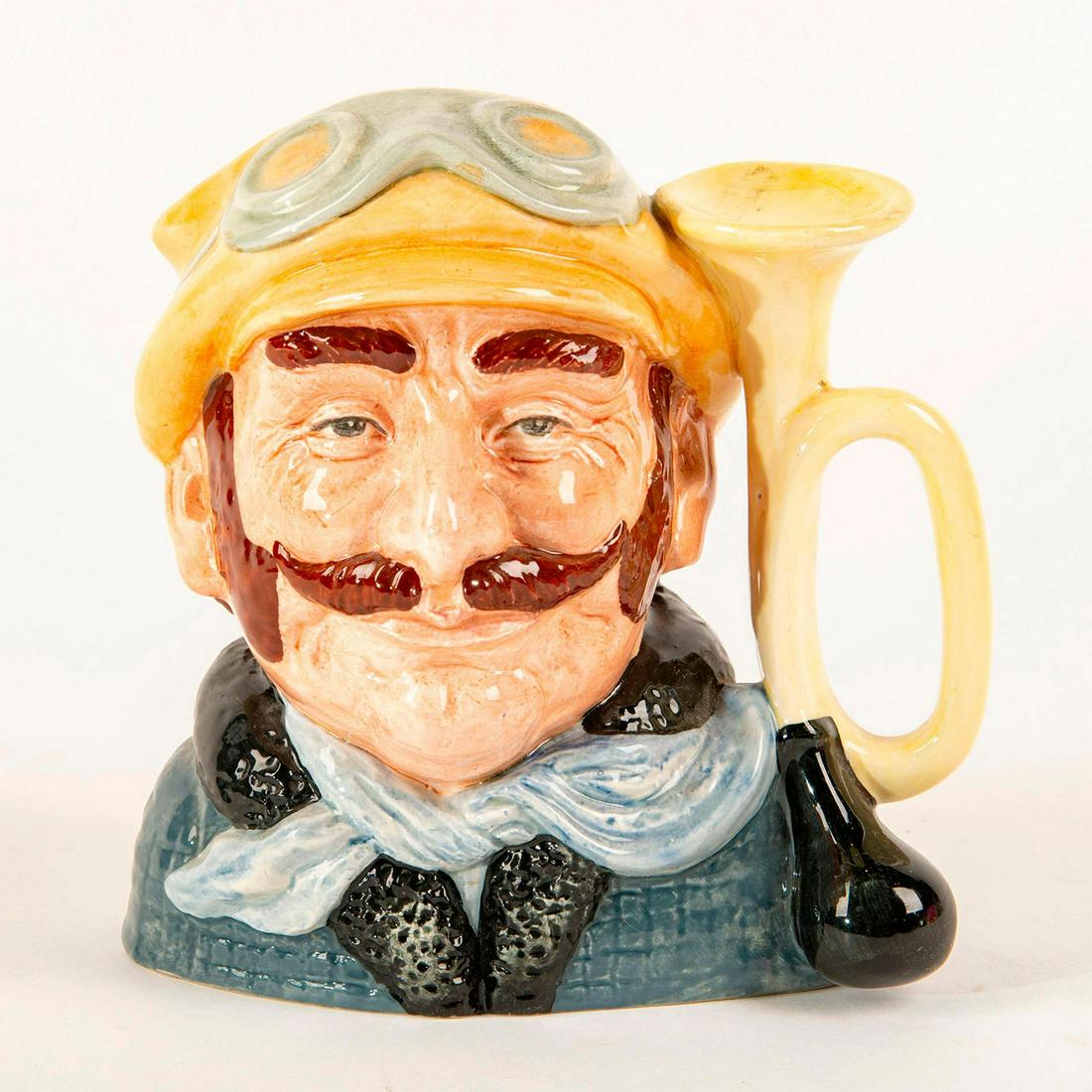 Vetern Motorist D6633 - Large - Royal Doulton Character: Hand decorated porcelain; Horn handle. Royal Doulton backstamp. Artist: David B. Biggs Issued: 1973 - 1983 Dimensions: 7.5"H Manufacturer: Royal Doulton Country of Origin: England