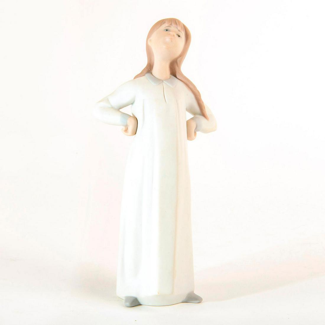 Girl Stretching 1014872 - Lladro Porcelain Figure: Matte finished figure; young girl dressed in all white. No Box. Issued: 1974-1991 Dimensions: 8"H Manufacturer: Lladro Country of Origin: Spain
