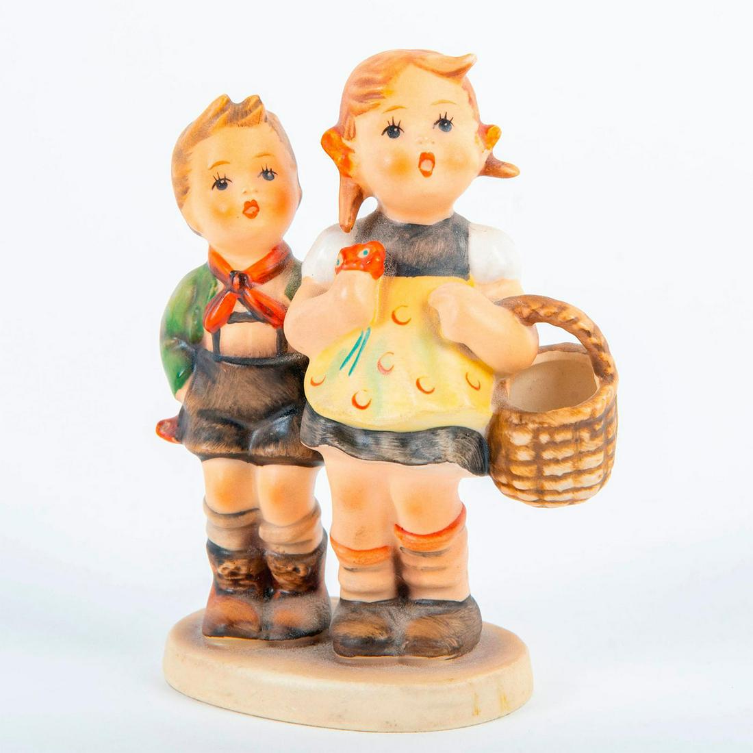 To Market - Goebel Hummel Figurine: Matte hand painted; boy and girl with basket. Impressed 49 3/0. 'To Market' sticker on back base as well as impressed signature. Goebel backstamp. Artist: M.Hummel Issued: 20th c. Dimensions: 4.5"H Ma