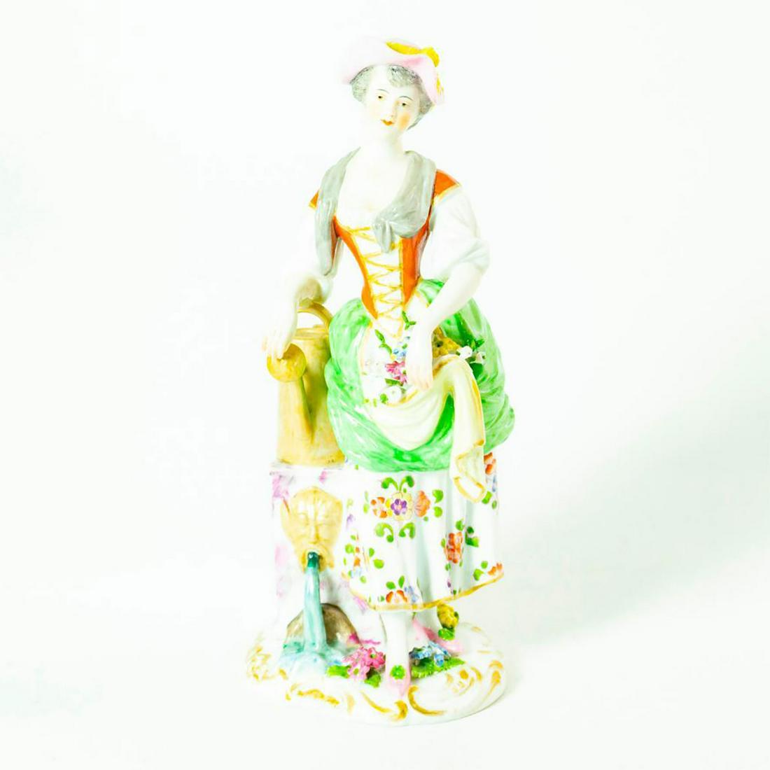 Meissen German Porcelain Figurine Country Woman with: Glossy porcelain figurine; Orange and green garments with floral dress. Woman standing by a marble water fountain. She has flowers being held in her dress. Several broken flowers in dress. Issued: 20t