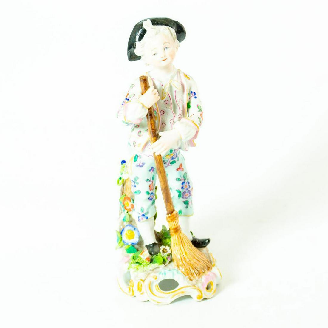 Meissen German Porcelain Figurine Victorian Boy: A glossy porcelain figurine of a young Victorian boy dressed in lavish floral garments. The happy lad carries his broom in hand. Broken flowers and vines around the base. Issued: 20th c. Dimensions: 6